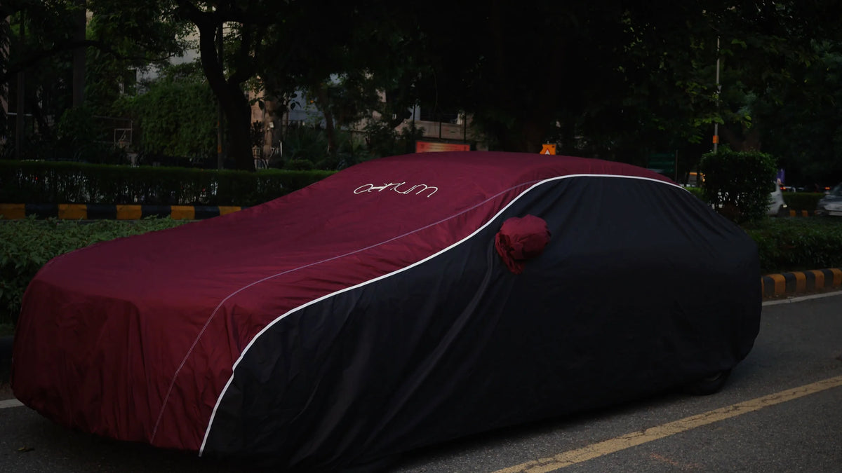 Oenum maroon and black car cover with white piping, fitted on a sedan