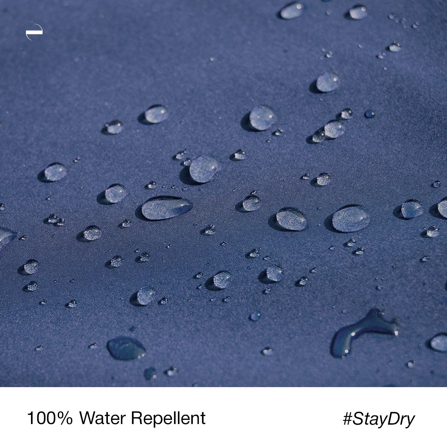 Close-up macro photo of the OENUM Plasma car cover's blue fabric surface, showing dozens of intact water droplets beading on top without soaking into the weave, demonstrating water-repellent performance; caption below reads '100% Water Repellent #StayDry.'