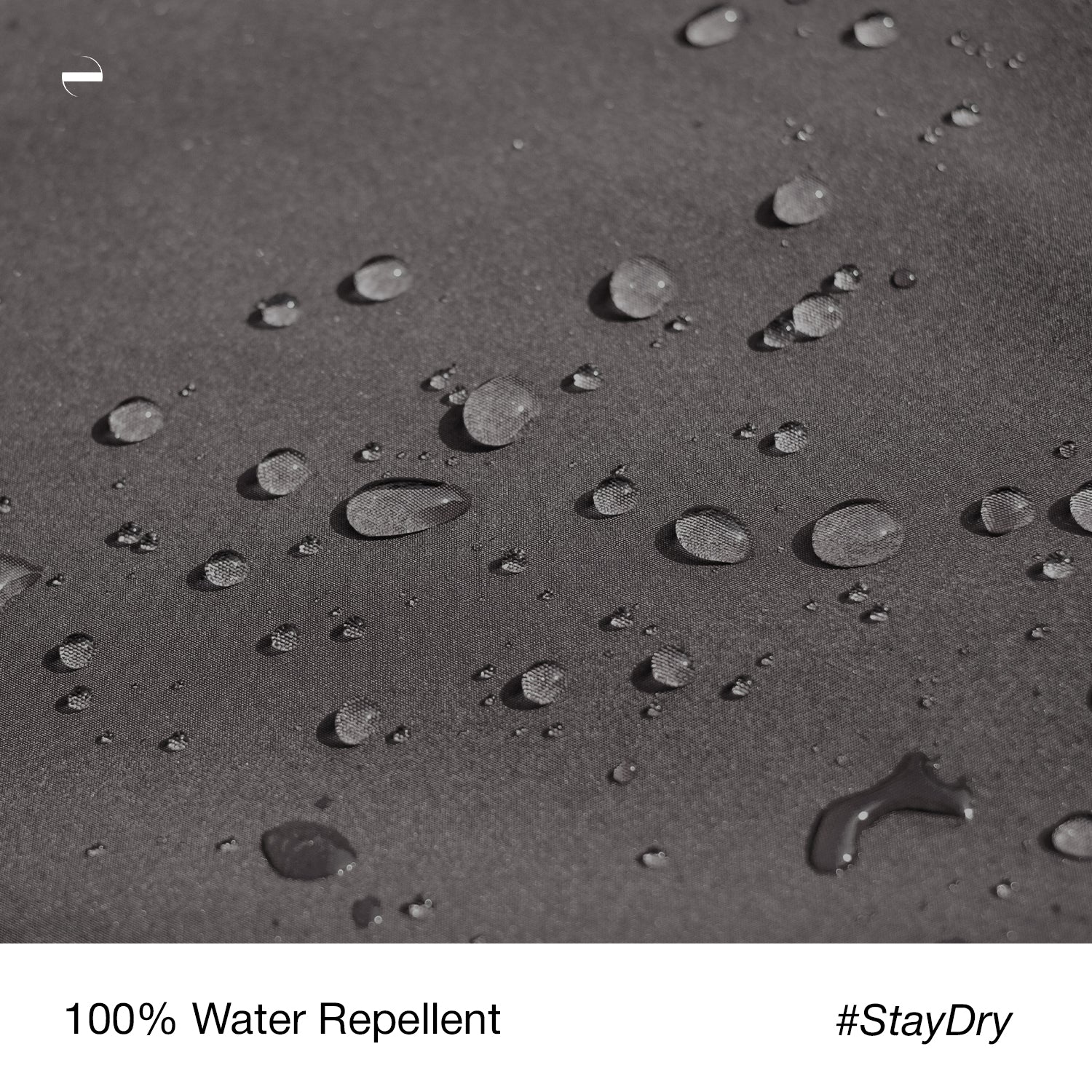Close-up macro photo of the OENUM Plasma car cover's black fabric surface, showing dozens of intact water droplets beading on top without soaking into the weave, demonstrating water-repellent performance; caption below reads '100% Water Repellent #StayDry.'