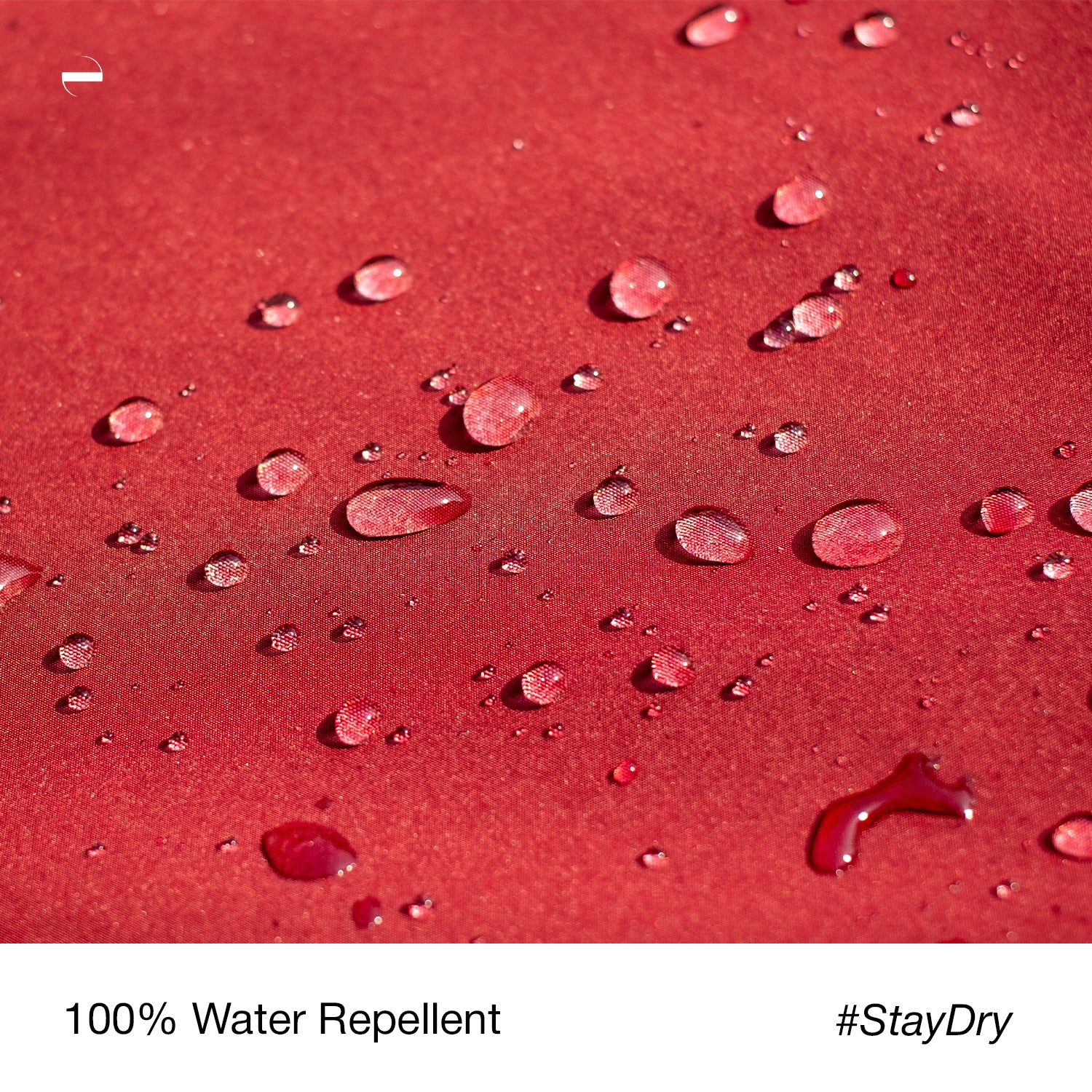 Close-up macro photo of the OENUM Plasma car cover's red fabric surface, showing dozens of intact water droplets beading on top without soaking into the weave, demonstrating water-repellent performance; caption below reads '100% Water Repellent #StayDry.'